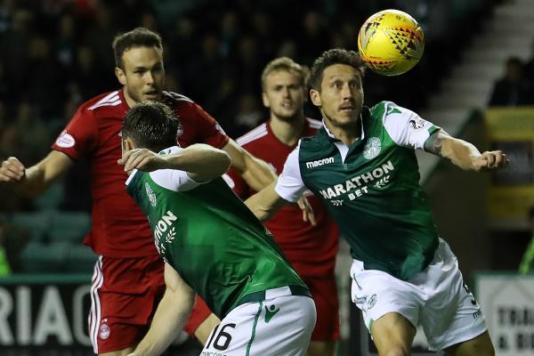 Mark Milligan in action for Hibernian.