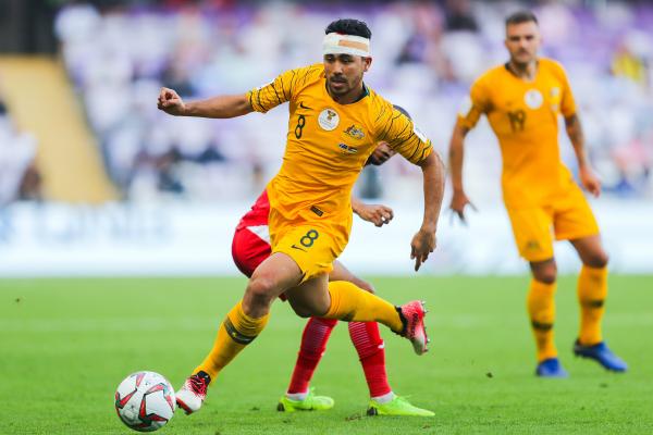 A bandaged Massimo Luongo drives forward from midfield.
