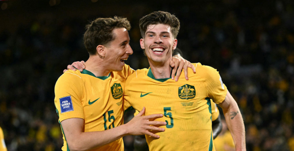 Australia's Jordan Bos (R) celebrates with teammate Riley McGree after scoring a goal during the international friendly football match between Australia and Cameroon at Stadium Australia in Sydney on March 27, 2026. (Photo by SAEED KHAN / AFP via Getty Images) / -- IMAGE RESTRICTED TO EDITORIAL USE - STRICTLY NO COMMERCIAL USE --
