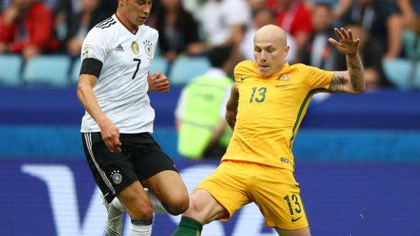 Aaron Mooy challenges for the ball with Germany's Julian Draxler.