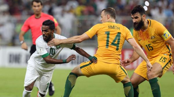 Brad Smith tries to block the passage of Saudi Arabia's Saudi's Nawaf Alabid in Jeddah.