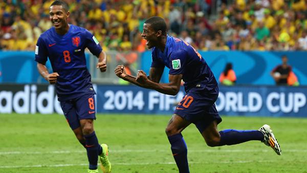 Georginio Wijnaldum of the Netherlands celebrates scoring his team's third goal with Jonathan de Guzman.