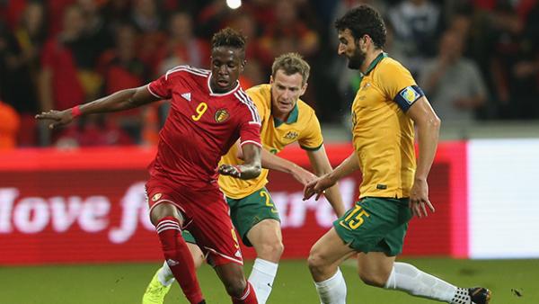 Belgium's Divock Origi shields the ball from Alex Wilkinson and Mile Jedinak.
