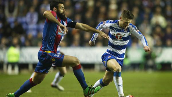 Crystal Palace skipper Mile Jedinak challenges for the ball with Reading's Oliver Norwood.