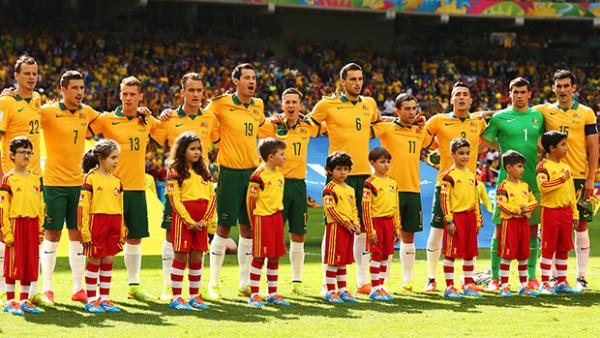 The Socceroos stand together during the national anthem in the match against Spain.