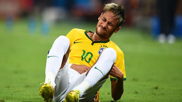 Brazilian star Neymar winces in pain after being injured in the win over Colombia.