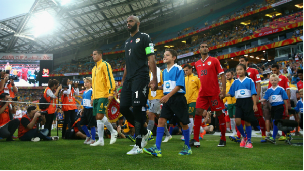 Oman and Australia's players take the field ahead of their clash at Stadium Australia.