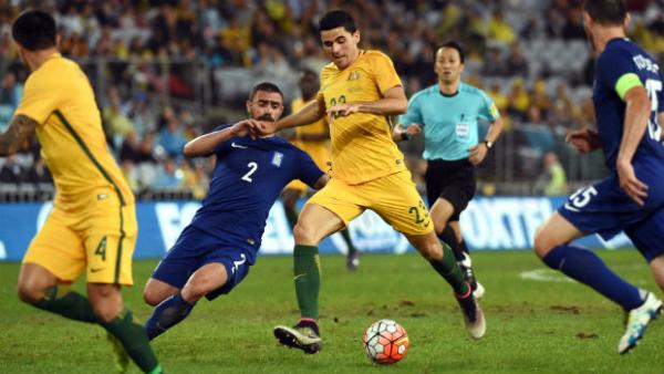 Midfielder Tom Rogic has a shot at goal against Greece at ANZ Stadium.