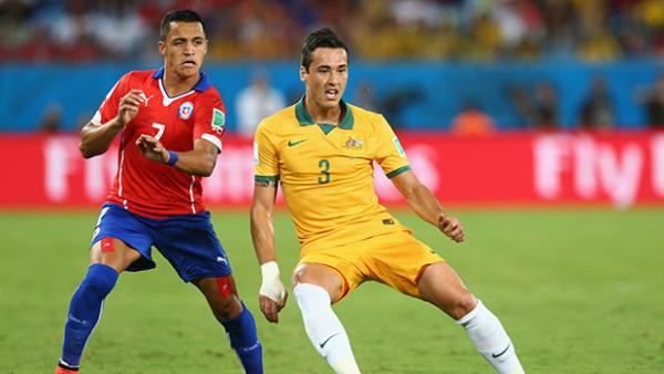 Socceroo Jason Davidson receives the ball under the attention of Chile's Alexis Sanchez.