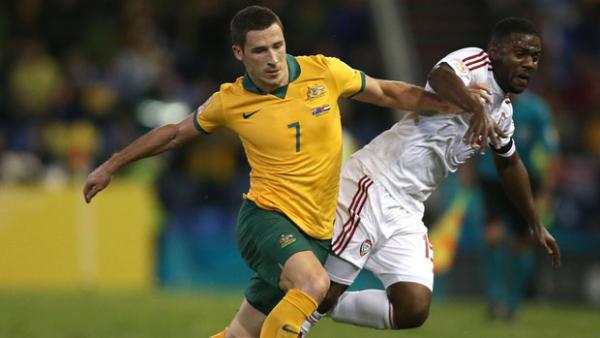 Leckie contests the ball with Ismail Al Hammadi of the United Arab Emirates.