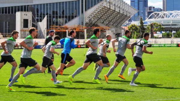 The Socceroos warm up ahead of a training session at their Melbourne base.