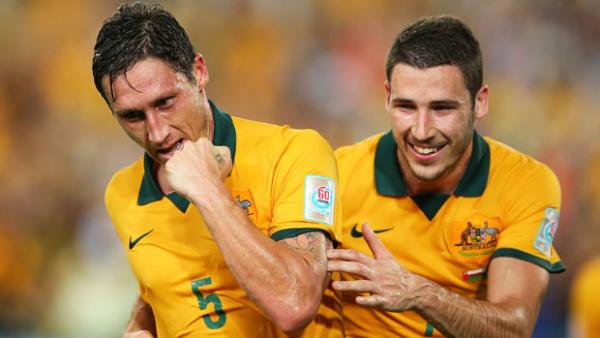 Milligan celebrates after scoring from the penalty spot against Oman.