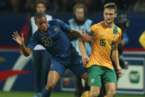 James Holland controls possession under pressure from France's Loic Remy.