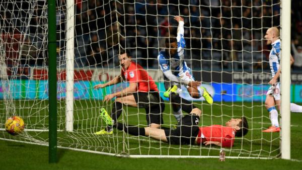 Aaron Mooy watches Elias Kachunga score Huddersfield's third goal against Brighton in the Championship.
