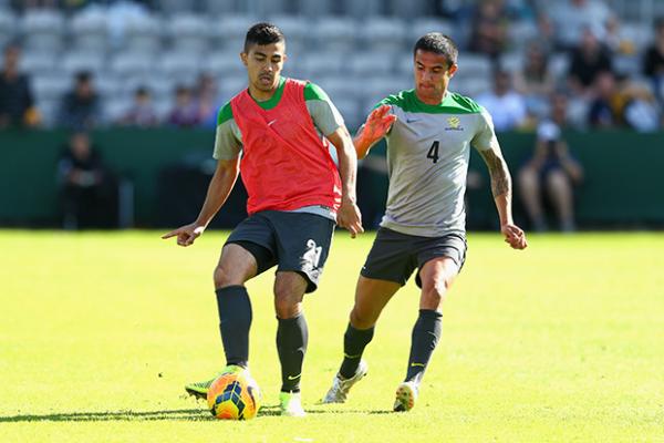 Massimo Luongo is shadowed by Tim Cahill in Socceroos training.