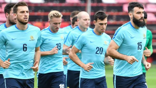 Mile Jedinak leads the Caltex Socceroos on a run during their World Cup qualifying campaign.