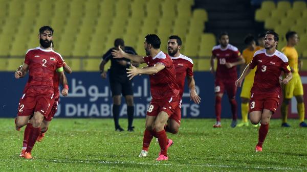 Syria players celebrate a goal against China in Malaysia.