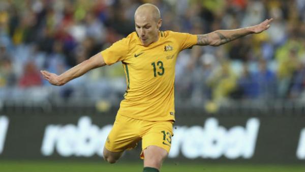 Midfielder Aaron Mooy takes a shot at goal against Greece at ANZ Stadium.
