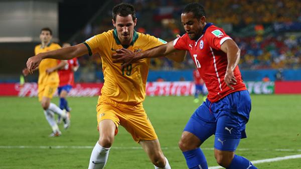 Ryan McGowan challenges Chile's Jean Beausejour.