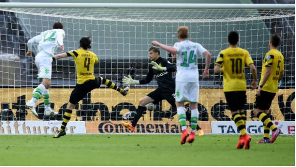 Mitch Langerak is unable to prevent Bas Dost from scoring VfL Wolfsburg's third goal.
