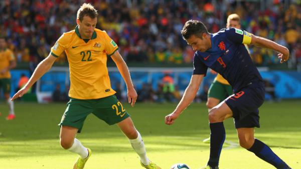 Wilkinson marshals Dutch superstar Robin Van Persie at the 2014 FIFA World Cup.