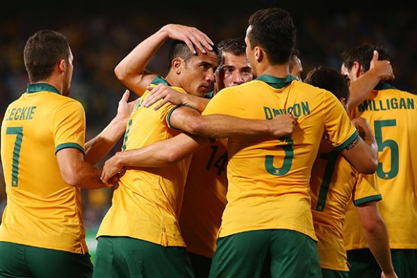 The Socceroos celebrate after Tim Cahill netted an equaliser with a trademark header.