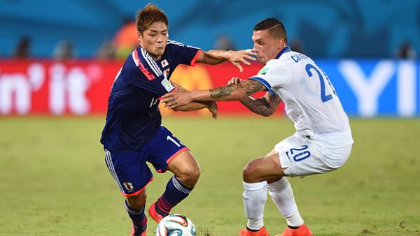 Japan's Yoshito Okubo and Greece's Jose Cholevas get in a tangle during their goalless draw.