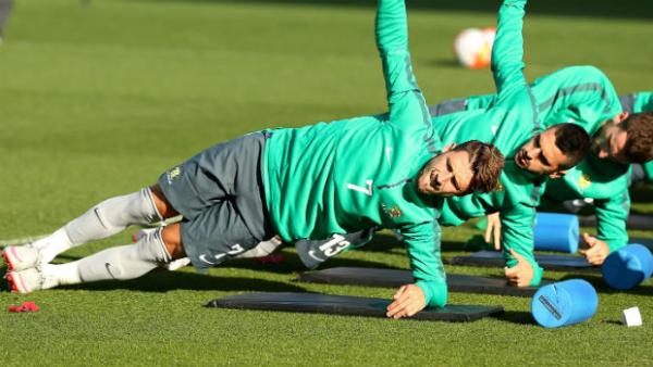 Forward Mathew Leckie stretches in camp with the Socceroos.