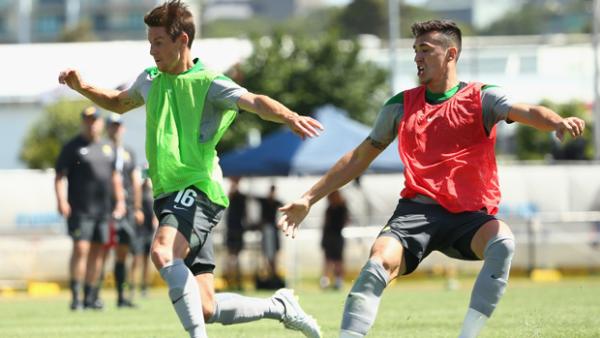 Socceroo striker Nathan Burns fights off the attention of defender Jason Davidson.
