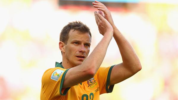 Alex Wilkinson salutes the Aussie crowd after the Socceroos loss to the Netherlands.
