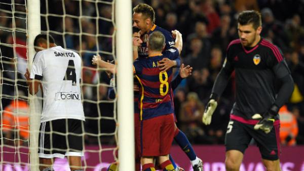 Barcelona players celebrate scoring against Valencia in their Copa del Rey semi-final.