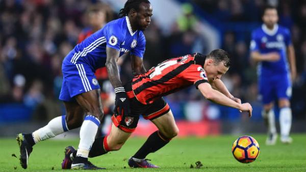 Brad Smith shields the ball from Victor Mosess at Stamford Bridge.