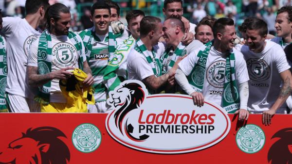 Tom Rogic celebrates with teammates after Celtic clinched the Scottish Premiership.
