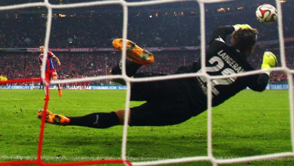 Mitch Langerak saves a penalty from Bayern Munich's Mario Goetze in the DFB Cup Semi Final.