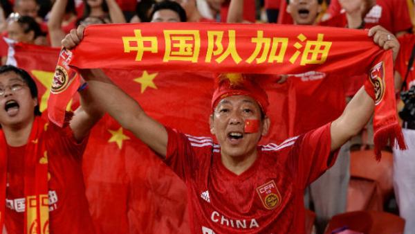 A Chinese fan supports his country during the match against Uzbekistan.