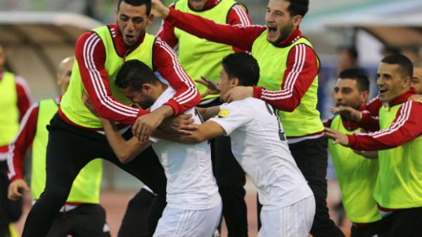 Hasan abdel Fattah celebrates scoring against the Socceroos in Amman.