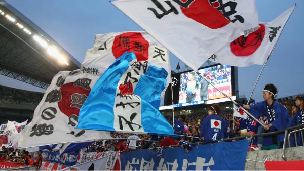 Japanese fans show their support during a friendly at Saitama Stadium.