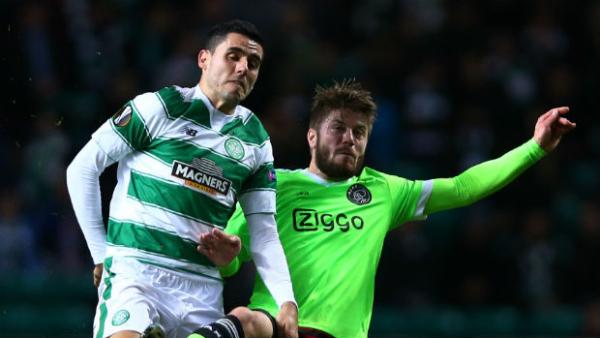 Tom Rogic and Ajax's Lasse Schone vie for the ball in Europa League action at Celtic Park.