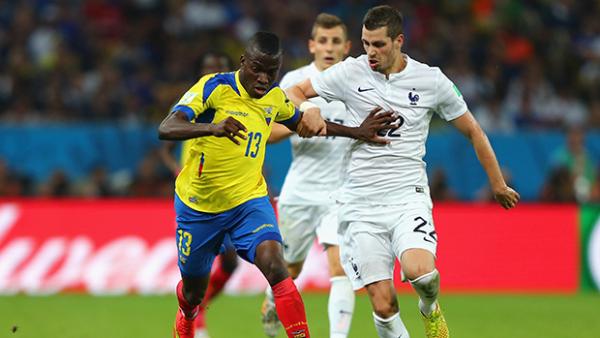 Morgan Schneiderlin challenges Enner Valencia during France's clash with Ecuador.