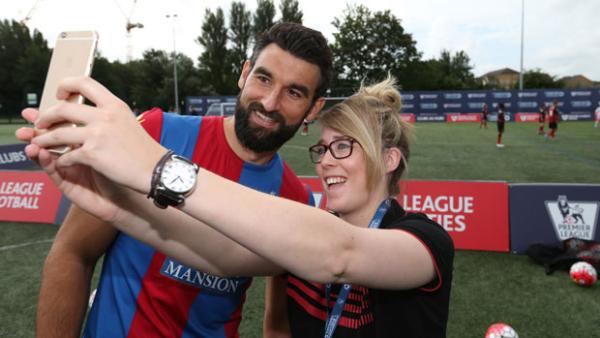 Mile Jedinak with a fan ahead of the new EPL season.