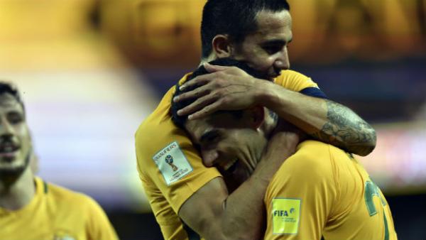 Tom Rogic receives a hug from Caltex Socceroos teammate Tim Cahill after scoring against Jordan.