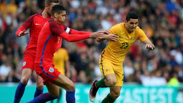 Socceroos playmaker Tom Rogic tangles for the ball with England defender Chris Smalling.