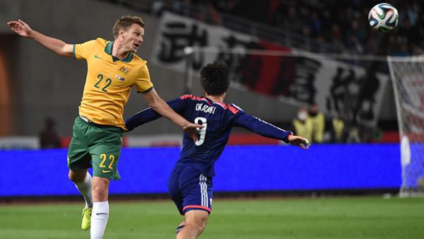 Alex Wilkinson clears the ball from Japan's Shinji Okazaki.