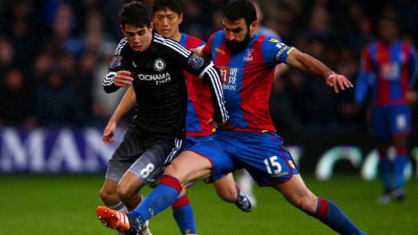 Mile Jedinak jostles for the ball with Chelsea midfielder Oscar.
