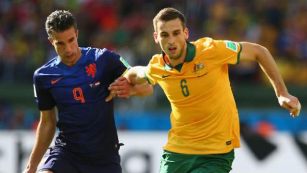 Socceroo Matt Spiranovic fends off the attention of the Netherland's Robin van Persie at the World Cup.
