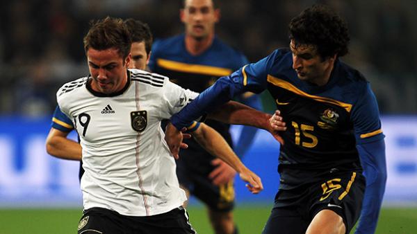 Germany's Mario Gotze fights for the ball with Socceroos Captain Mile Jedinak in a friendly in 2011.