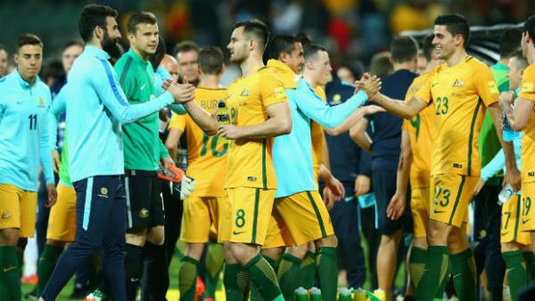 Mile Jedinak and Bailey Wright shake hands after the Socceroos beat Tajikistan in Adelaide.