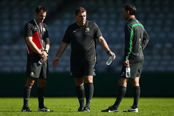 Socceroos coach Ange Postecoglou discusses team tactics with assistants Ante Milicic and Aurelio Vidmar at training this week.