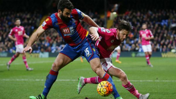 Crystal Palace captain Mile Jedinak jostles for the ball with Bournemouth's Harry Arter.