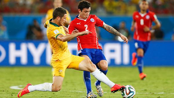 Socceroo Mathew Leckie wrestles the ball from Chile's Eugenio Mena.